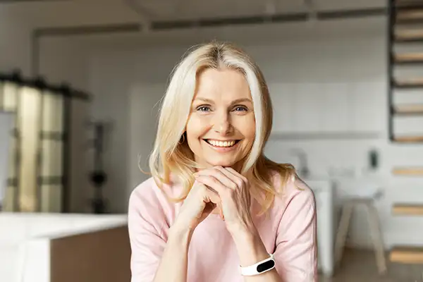 A woman smiling while looking at camera.