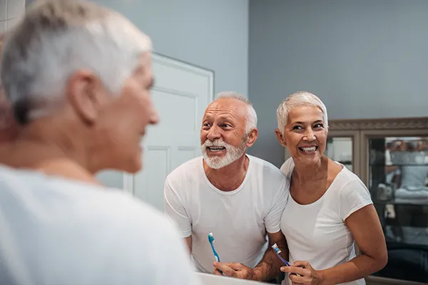 image of mature couple brushing teeth AdobeStock 195794291