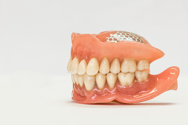 Set of full dentures on a white background.